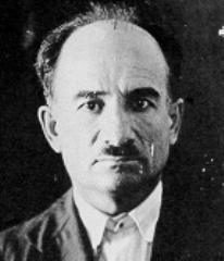 Portrait photograph of Mario Buda, looking at the camera; he is balding and has a short moustache