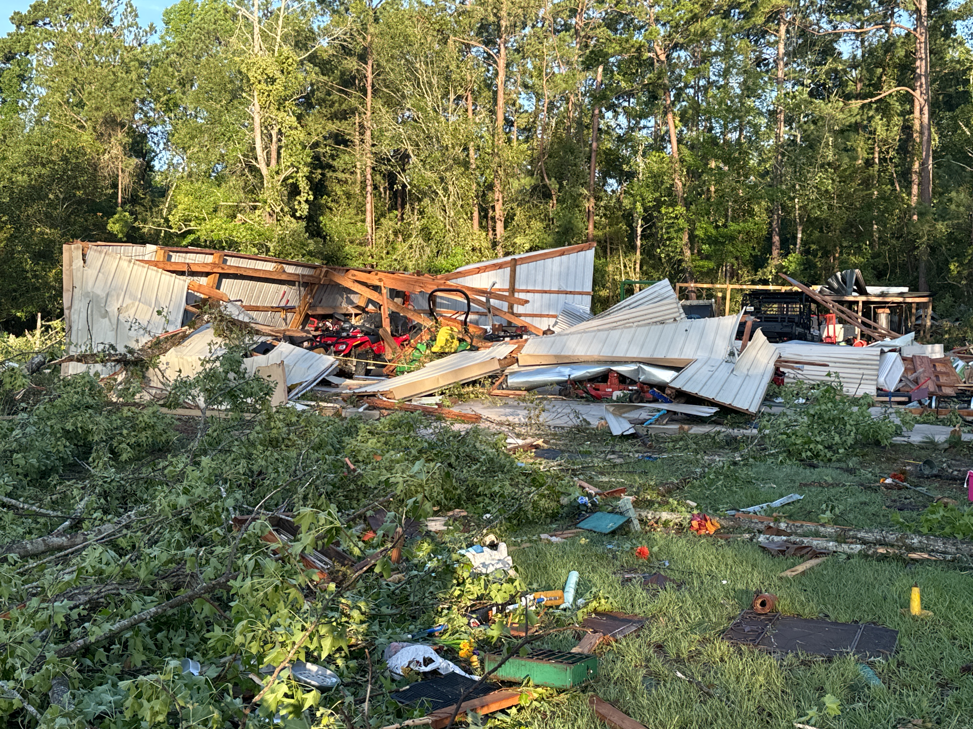 EF2 damage to trees and a destroyed outbuildings on the southwest side of Jasper, Texas.