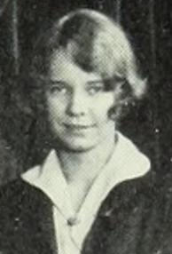 A young white woman with light hair cut in a wavy bob with a sidepart