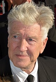 A close-cropped head shot of a man with silvery hair