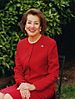 Smiling woman wearing earrings and a red shirt