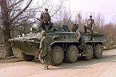 An American soldier examines a Russian BTR-80 on patrol in Bosnia, 1996