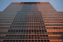 The facade of 2 Broadway after it was renovated. The picture was taken during sunset, making the facade look pink and brown instead of blue-green.