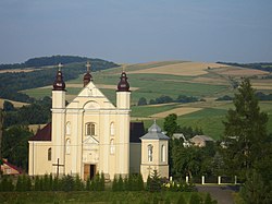 Main street in Nowotaniec, the centre of village. The latin church parish and Bukowica hill.