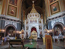 An ornate altar surrounded by several iconographic depictions of saints.