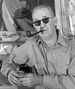 Black-and-white photograph of John Ford smoking a pipe.