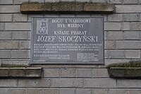 Plaque of Fr. Józef Skoczyński on the facade of the cathedral basilica in Stalowa Wola