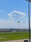 The fire producing a pyrocumulus cloud while burning in the Bradshaw Mountains