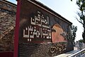 Monument on the mosque's west side featuring Quranic verse 55:17