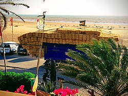 Transport of straw on a road along the beach