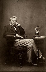 A portrait of Willis, sitting in a chair