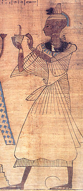 Gemälde eines Mannes mit aufwändigem Gewand und kahlgeschorenem Kopf. Er hält einen Becher hoch, aus dem eine Rauchfahne aufsteigt.