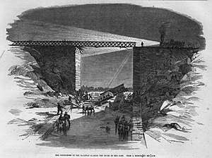 Sketch of rescuers on the frozen canal with searchlights above.