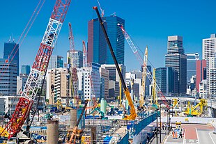 Takanawa Gateway City under construction w/ Azabudai Hills in the back