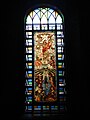 The large stained-glass window by the main altar depicting the Resurrection of Christ