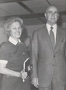 Smiling woman next to man in suit