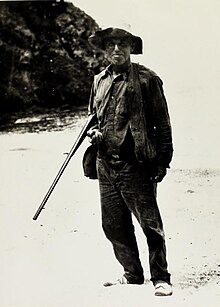 Photo of man holding rifle.