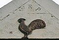 WRP (William Ralston-Patrick) and cockerel carving on the wall of the farm