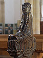 A poppy head pew end depicting Sloth