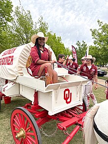 Jadyn Davis, the first African American woman to drive the Sooner Schooner, on the box of the schooner.