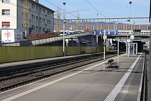 Island platform and side platform with road bridge crossing above