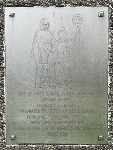 Image showing metal plaque depicting a nun with two children and words commemorating the first school patrol crossing in Saint Paul Minnesota on February 17, 1921