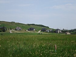 The eastern part of the hamlet of Millarville, looking ENE from Highway 549. Highways 22 is visible near the right edge of the image.