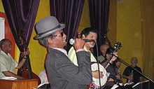 "Uncle" Lionel Batiste (in derby hat) with "Papa" Don Vappie (with banjo)