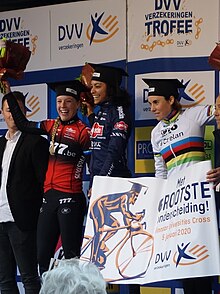 Top 3 riders of the 2020 Brussels Universities Cyclocross on the podium wearing graduation caps.