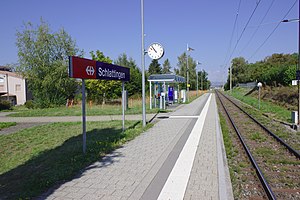 Single railway track, asphalt platform, and shelter