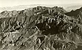 1937 aerial view of Lost Mine Peak centered at top, from WNW.