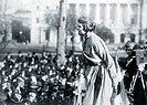 Suffragist Lucy Branham addresses a crowd wearing her prison uniform