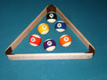 A set of Aramith-brand 16–21 pool balls for playing baseball pocket billiards. They are added to an existing set of 1-15 American-style pool balls, and racked using the illustrated oversized triangle for 21 balls.