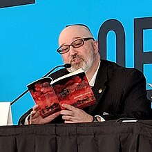 Poet Gregory Crosby reads from his book at the 2018 Las Vegas Book Festival.