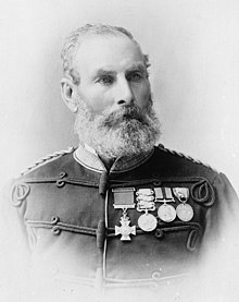 Head and chest portrait of bearded man in uniform wearing medals