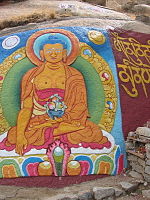 Buddha painted on a rock wall