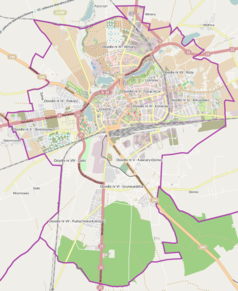 Mapa konturowa Gniezna, blisko centrum u góry znajduje się punkt z opisem „Cmentarz św. Krzyża w Gnieźnie”