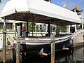 The African Queen docked under a canvas roof.