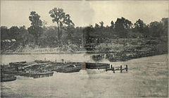 Sepia toned photo shows a river with obstructions in it.