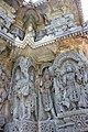 Relief of Hindu deities below lower eve and miniature decorative towers above it (below upper eve) in the Kedareshwara temple at Halebidu