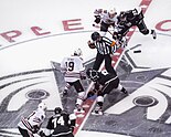 Former NHL referee Marc Joanette prepares for an opening faceoff in a 2013 NHL Western Conference contest between the Chicago Blackhawks and the Los Angeles Kings.