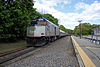 A Downeaster train passes the Ballardvale MBTA station in 2013