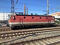 1144 052 in a train yard; this locomotive has the original (smaller) ventilation intakes on the sides