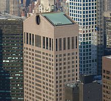 The top of the building as seen from a distance in 2015. There is an open pediment on the building's roof.