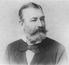 Gentleman with beard wearing victorian suit and bow tie