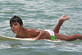 Boy learning to surf off Barra, Brazil