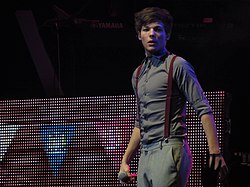 Louis Tomlinson on stage during One Direction's Up All Night Tour in 2012