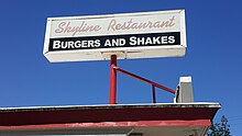 Photograph of a sign with the text "Skyline Restaurant" and "Burgers and Shakes"