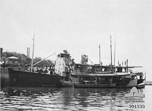 HMAS Southern Cross at Darwin during July 1942. The lugger HMAS Griffioen is moored alongside her