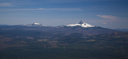 The smaller Belknap formed on the lower slopes of the larger Mount Washington, which is larger in size and height